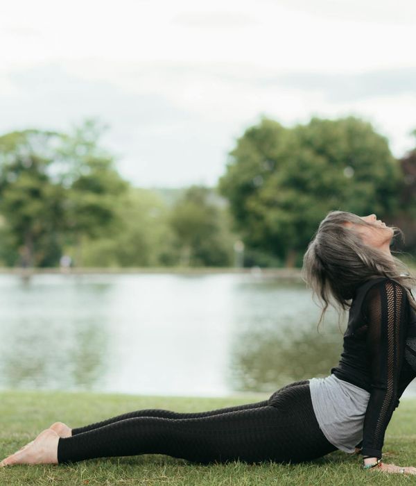 Woman practicing a serene yoga pose in a calm environment.
